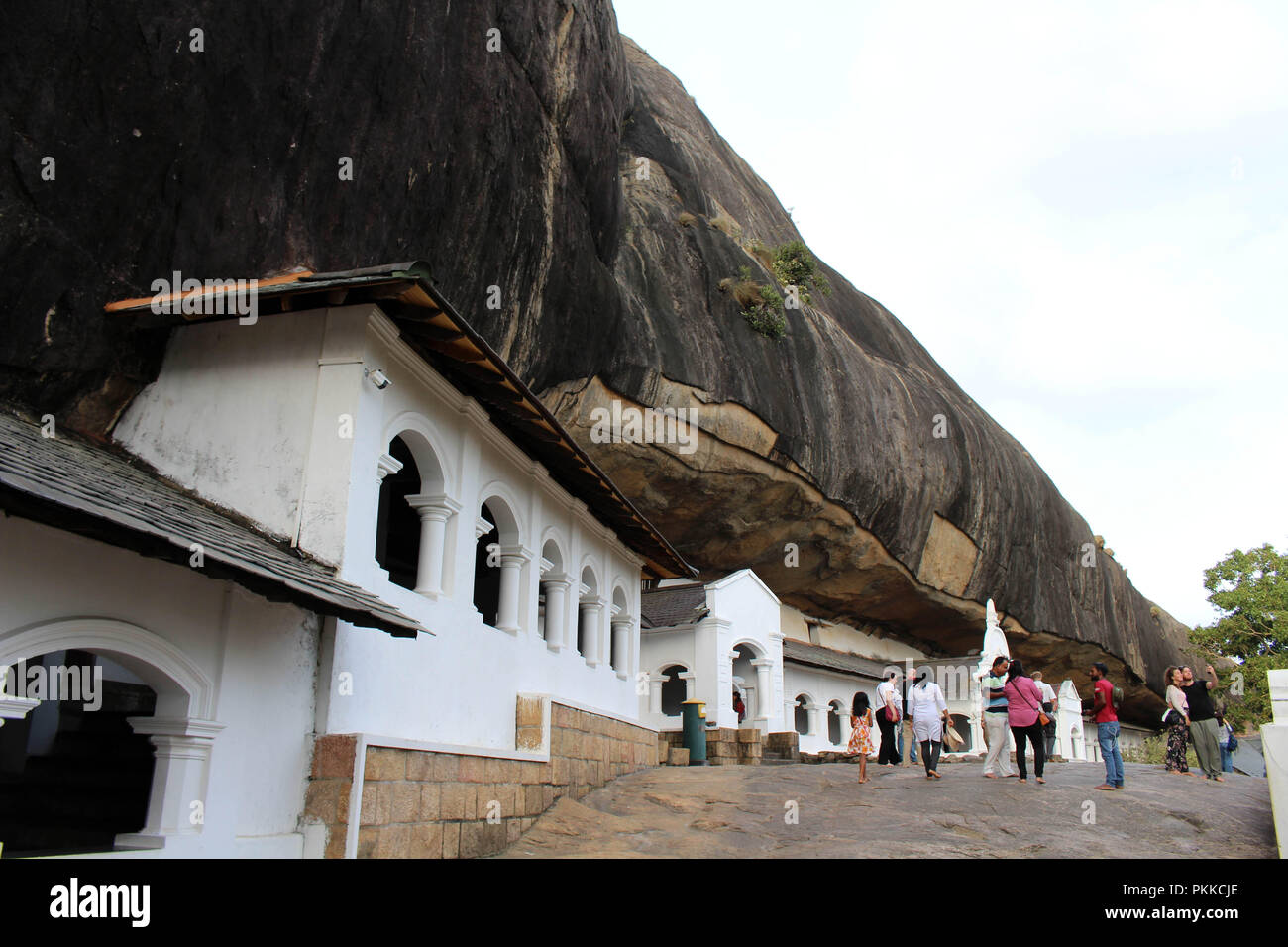 People, pilgrims, and tourists around the Dambulla Cave Temple. Taken in Srilanka, August 2018. Stock Photo