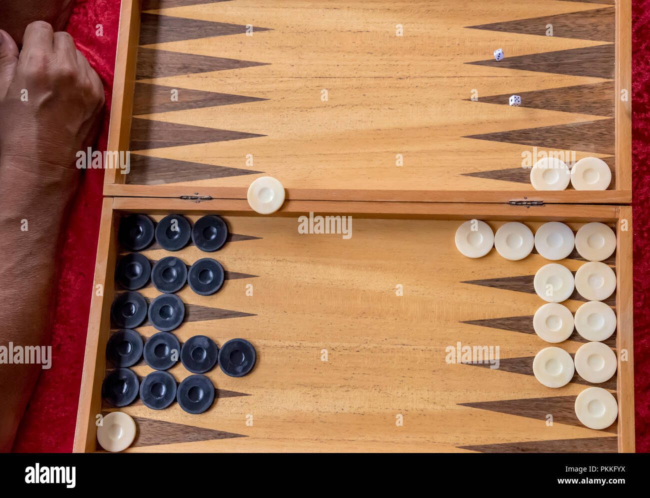 man throws dice while playing tabla. Top view Stock Photo