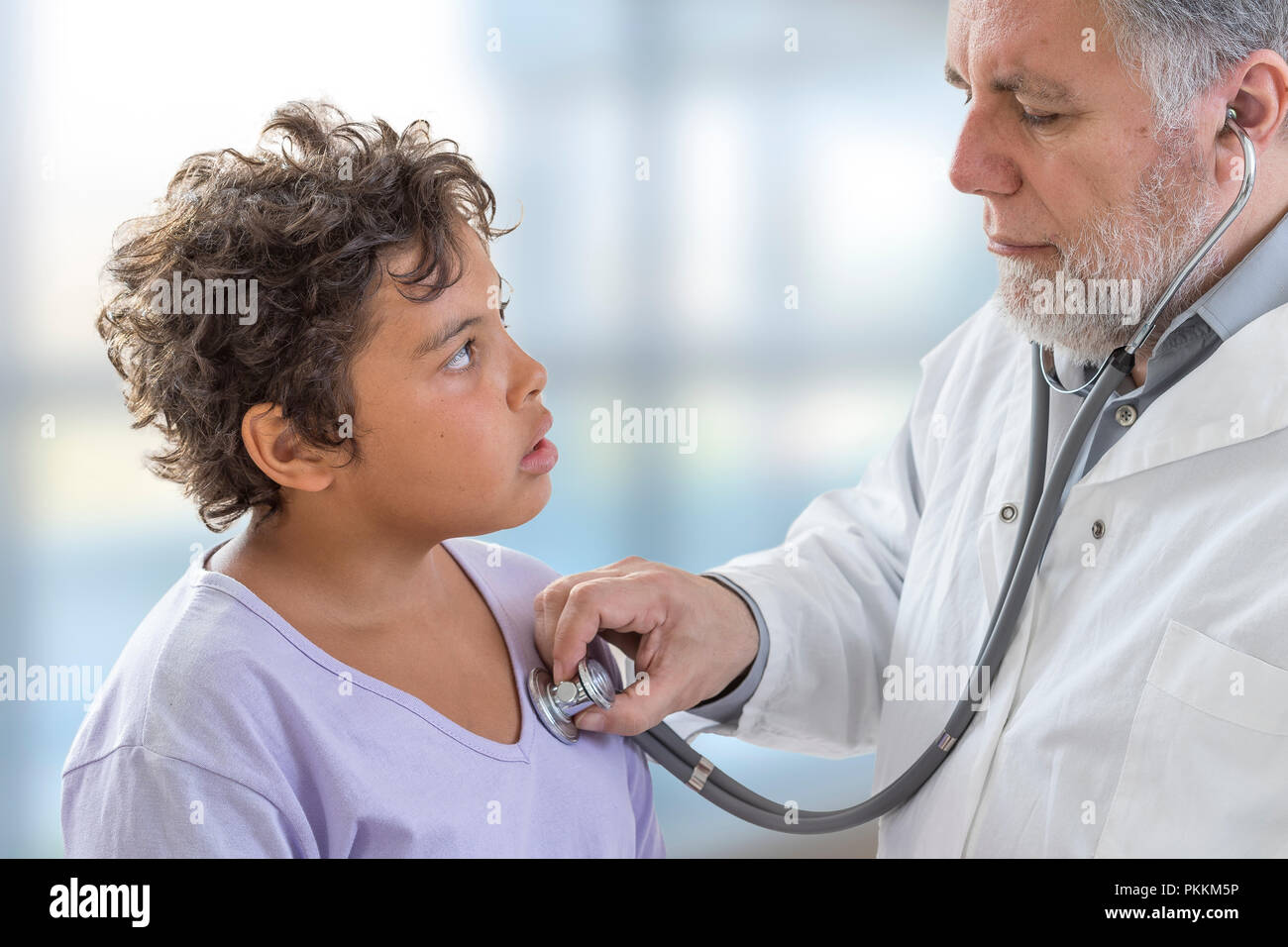 Young Teenage Check Up. Doctor Listens to Heart Rate with Stethoscope Stock Photo