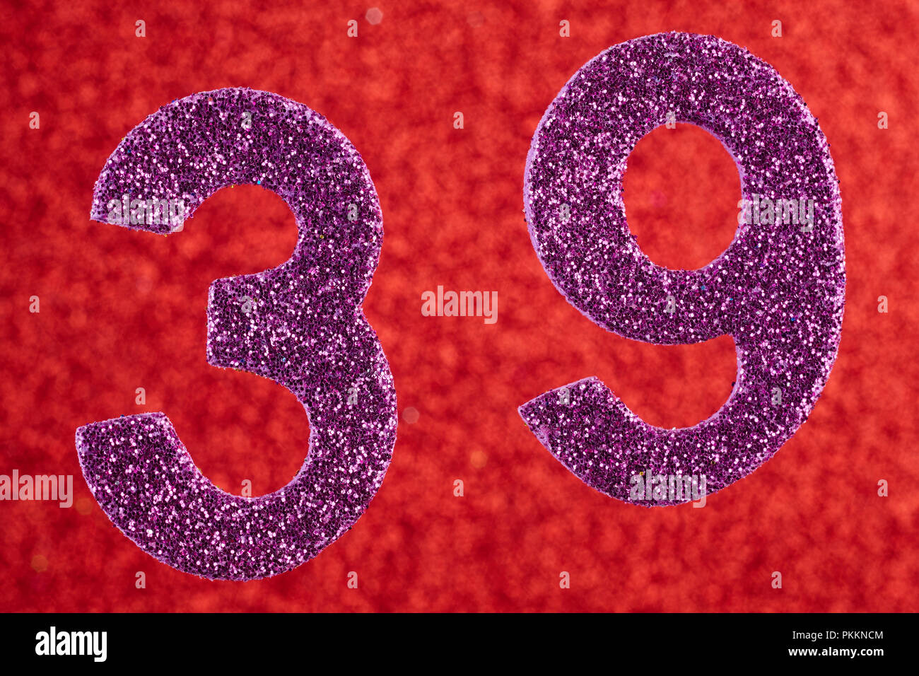Number thirty-nine purple color over a red background. Anniversary. Horizontal Stock Photo