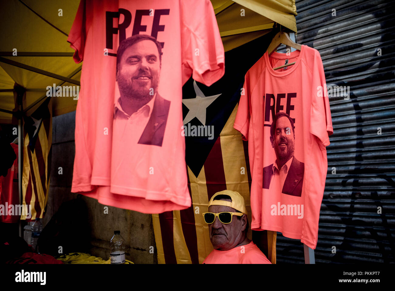 T-shirts demanding freedom for former Catalan vice-president ORIOL JUNQUERAS are displayed in a stall during La Diada in Barcelona.  Catalans celebrate La Diada or Catalonia National Day in an atmosphere of conflict with the Spanish Government for the imprisoned independentist leaders and proclamations in favor of independence. Stock Photo