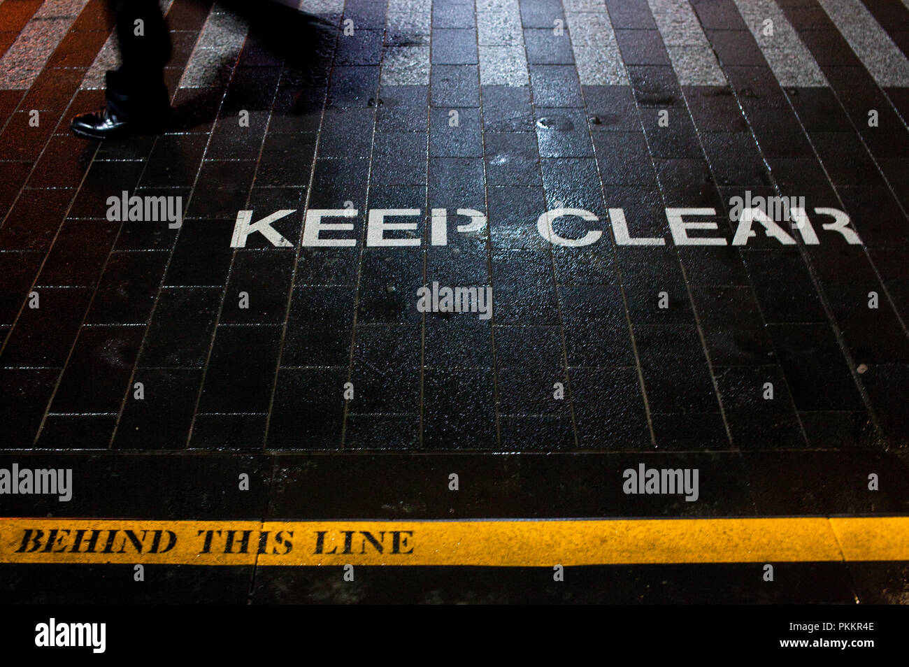 'Keep Clear Behind This Line' safety indicators on a Melbourne tram stop in the central business district. Stock Photo