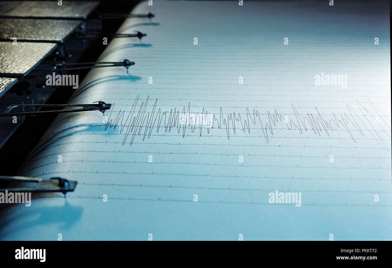 Swinging needle of seismograph at earthquake. Stock Photo