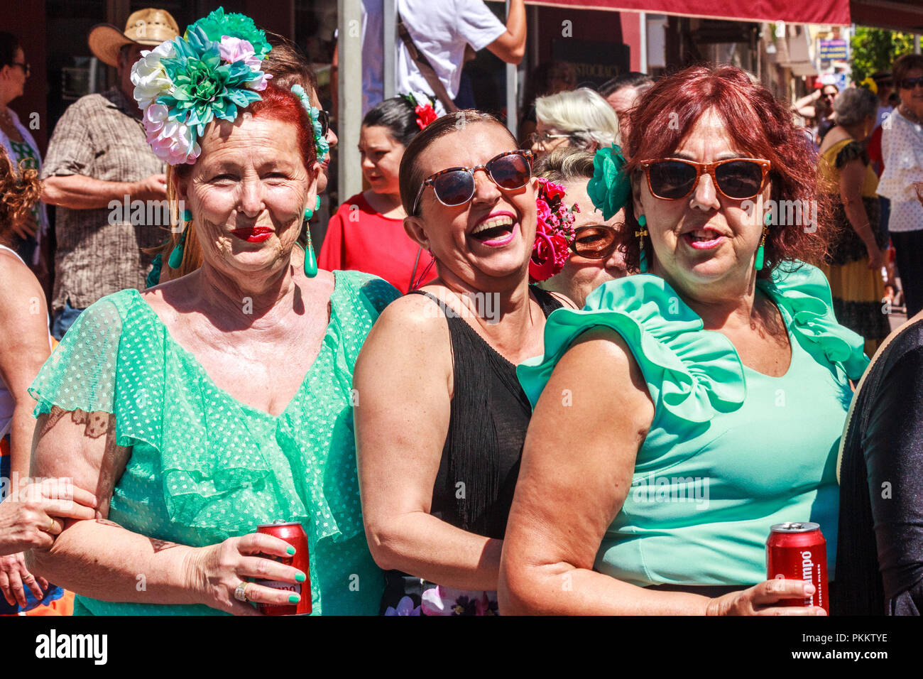 Arroyo de la Miel, Spain - 17th June 2018: Smiling Spanish women enjoying a drink at a local fiesta. Spain is famous for its fiestas. Stock Photo