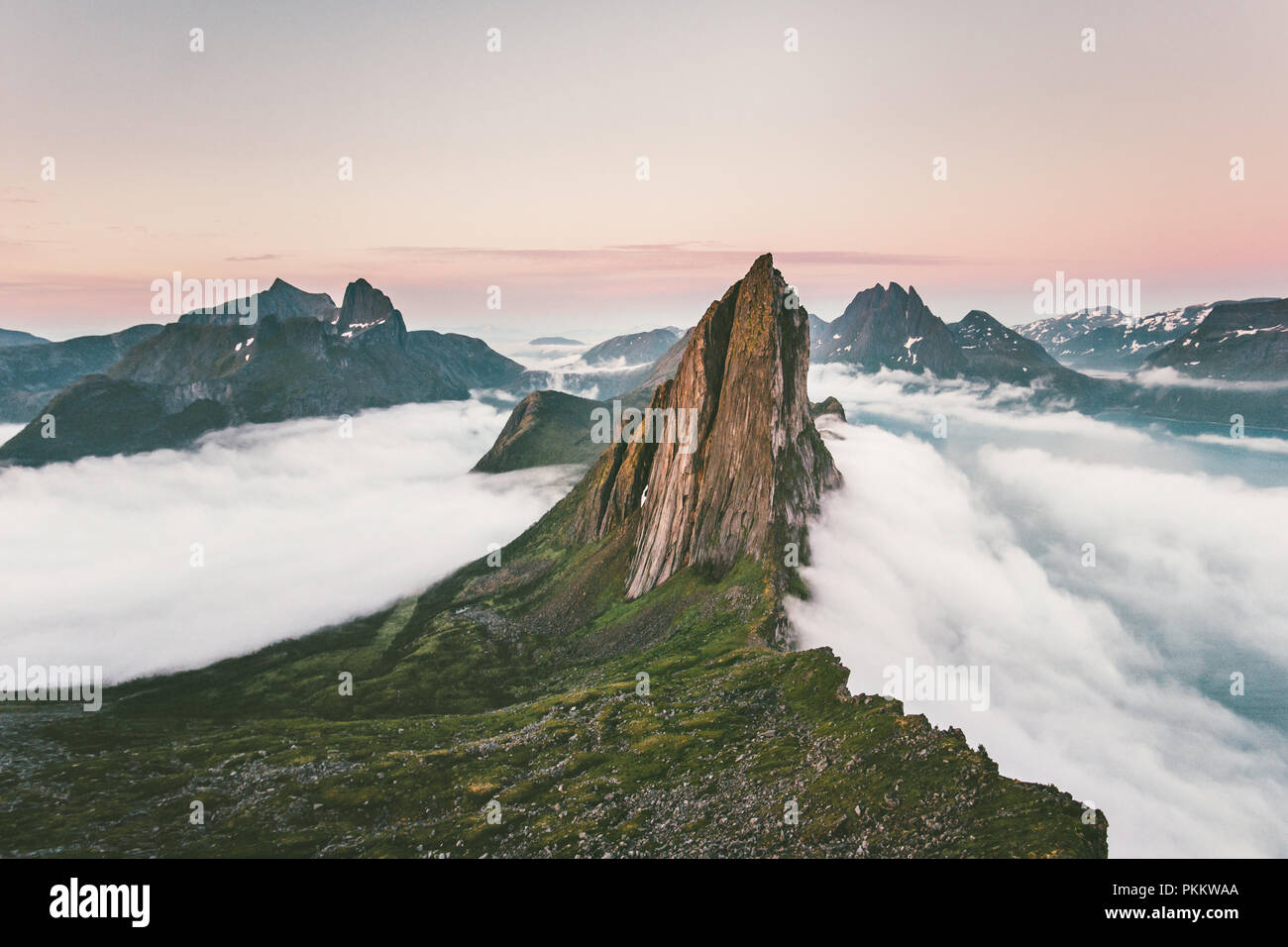 Segla Mountain rocky peak Landscape over clouds and fjord aerial view in Norway Travel destinations awesome scenery Senja islands Stock Photo