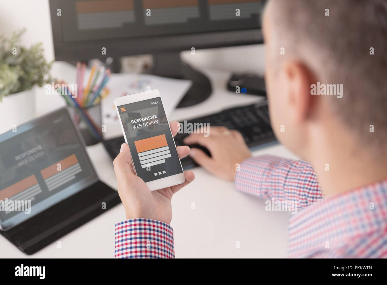 Designer working on responsive web design project. Web developer and ...