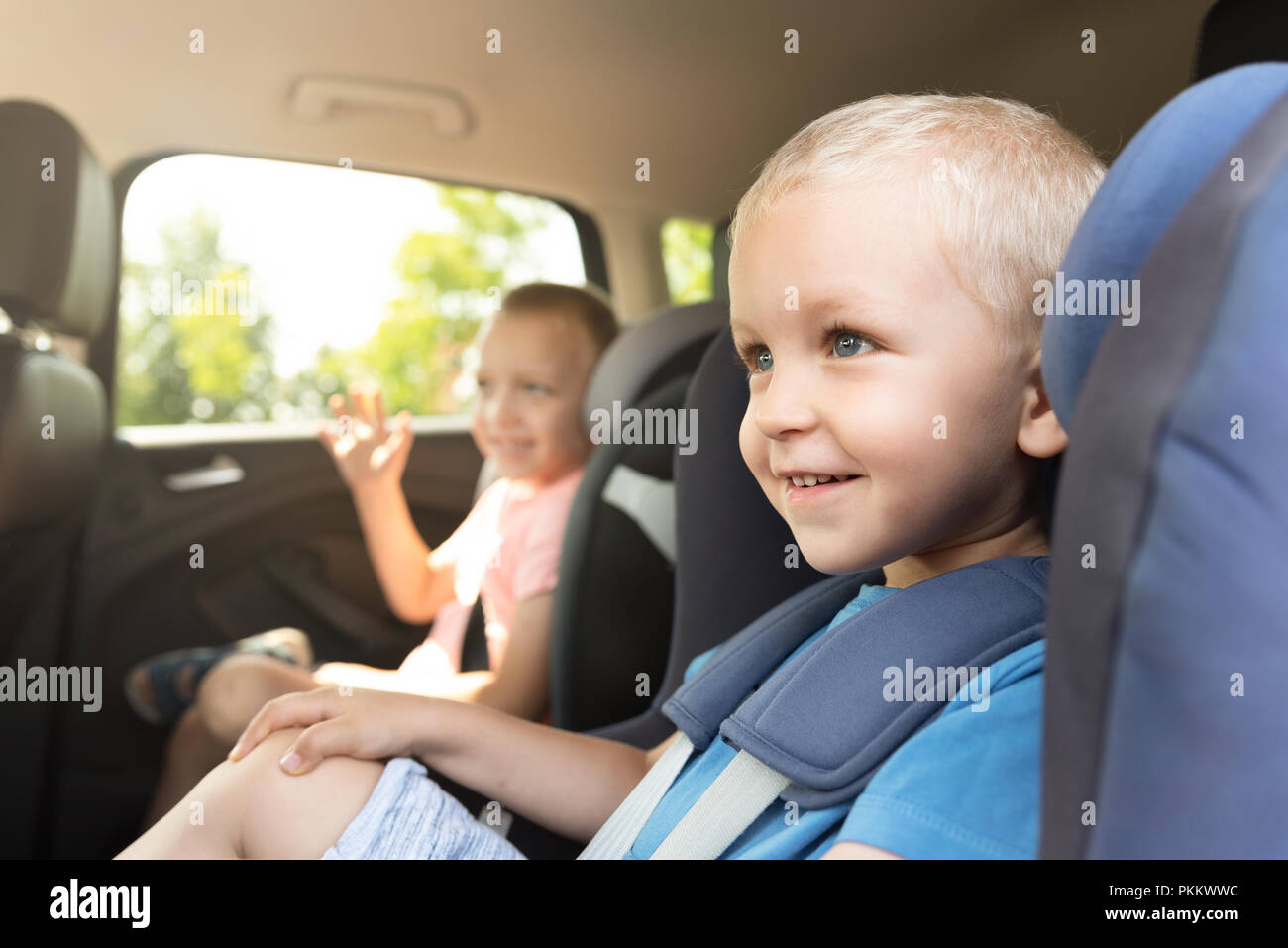 Boy buckled into car seat. Safe family travel concept Stock Photo