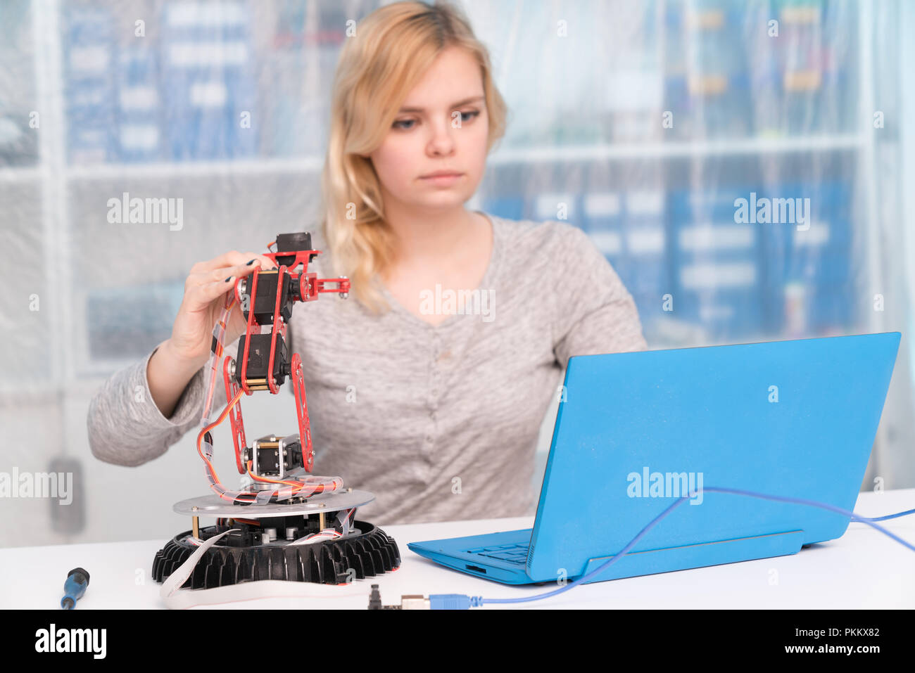 young engineer adjusting intelligence toy robot Stock Photo