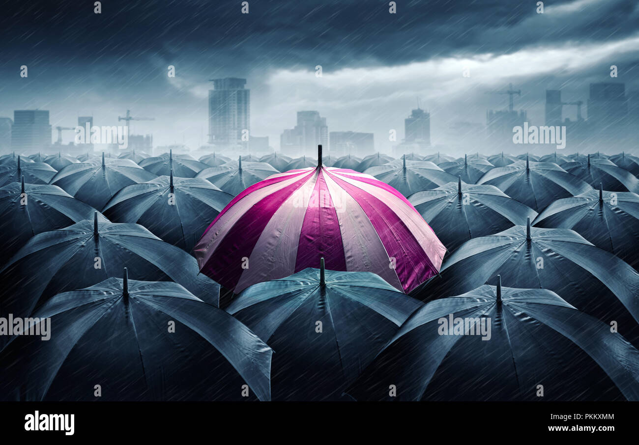 Pink and white umbrella with dark stormy clouds. Concept for success. Stock Photo