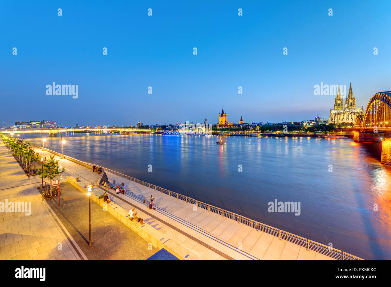 The river banks of the Rhine river in Cologne after sunset Stock Photo
