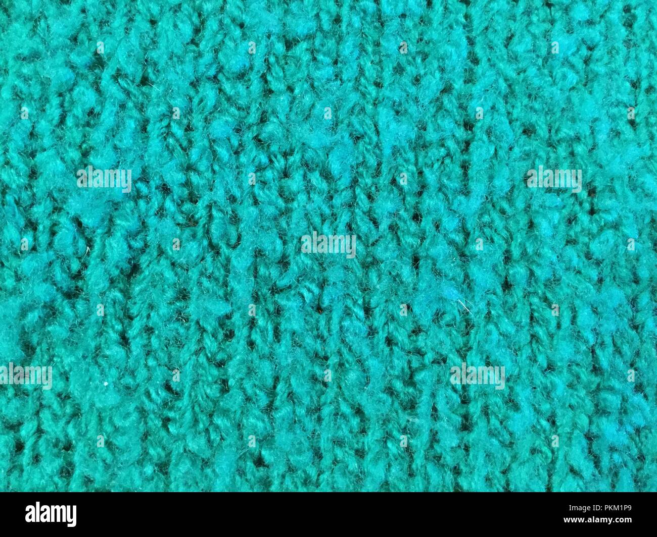 Macro view of green knitted fabric showing texture and design Stock ...
