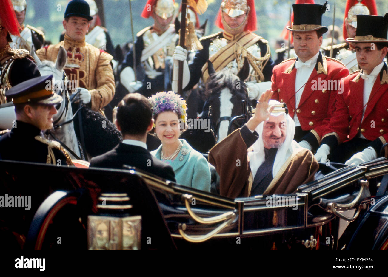 A State Visit in May; 1967; Her Majesty Queen Elizabeth ll, accompanied by her husband, the Duke of Edinbugh (Prince Phillip), rides in an open carriage with King Faisal of Saudi Arabia on the Mall towards Buckingham Palace. They are escorted by guards in ceremonial dress. Stock Photo