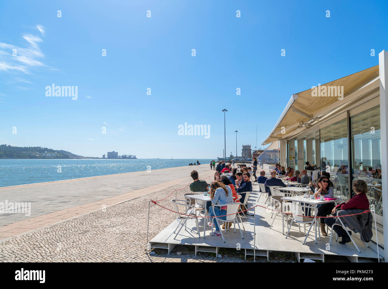 Waterfront restaurant looking towards the Belem Tower, Belem district, Lisbon, Portugal Stock Photo