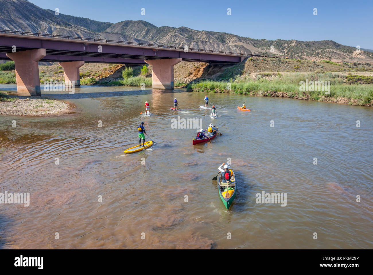 Dotsero, CO, USA  - August 19, 2012: Stand up paddleboards, kayaks and canoes in the annual Colorado River Race in the Glenwood Canyon. Stock Photo