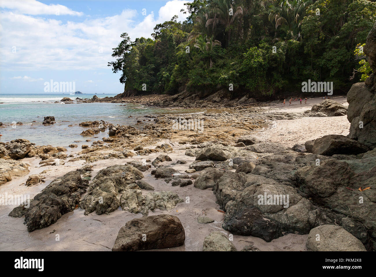 Rocks, sand and jungle in a small beach at the Manuel Antonio National Park in Costa Rica Stock Photo