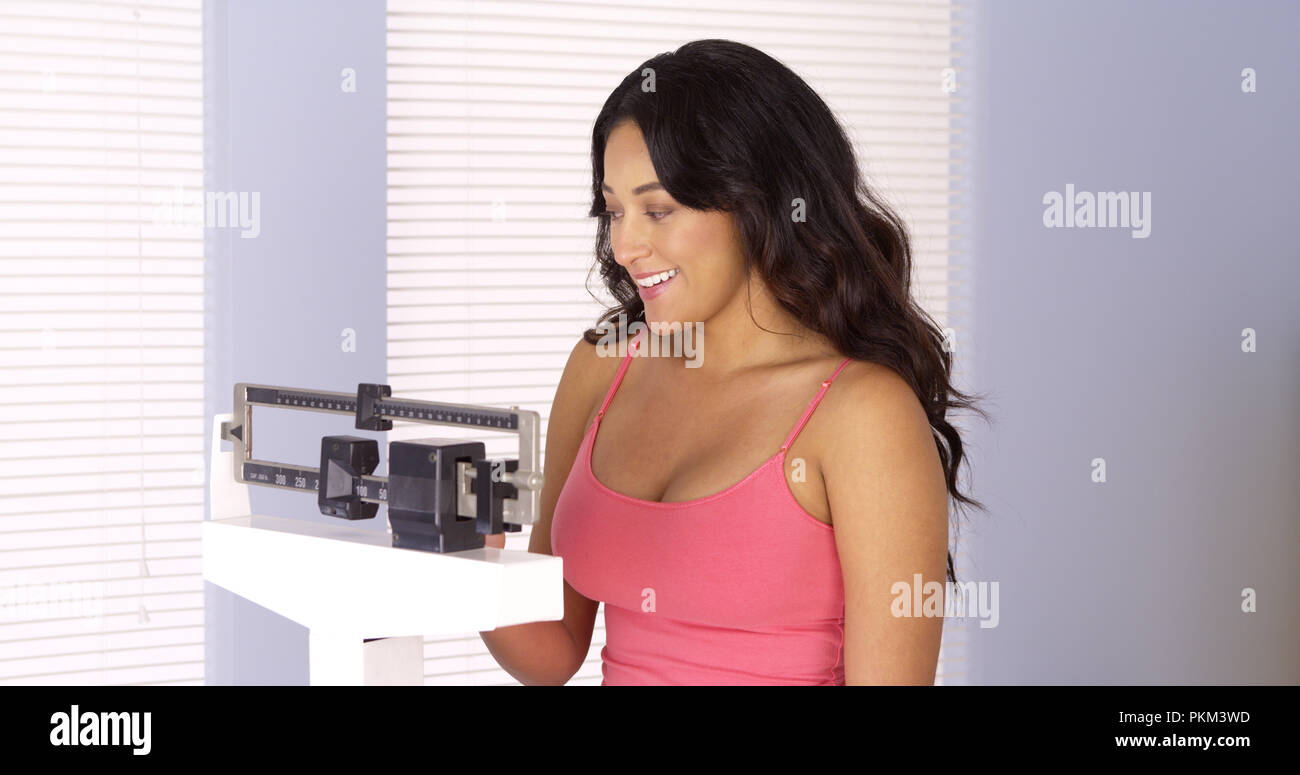Mexican woman happy after checking her weight Stock Photo