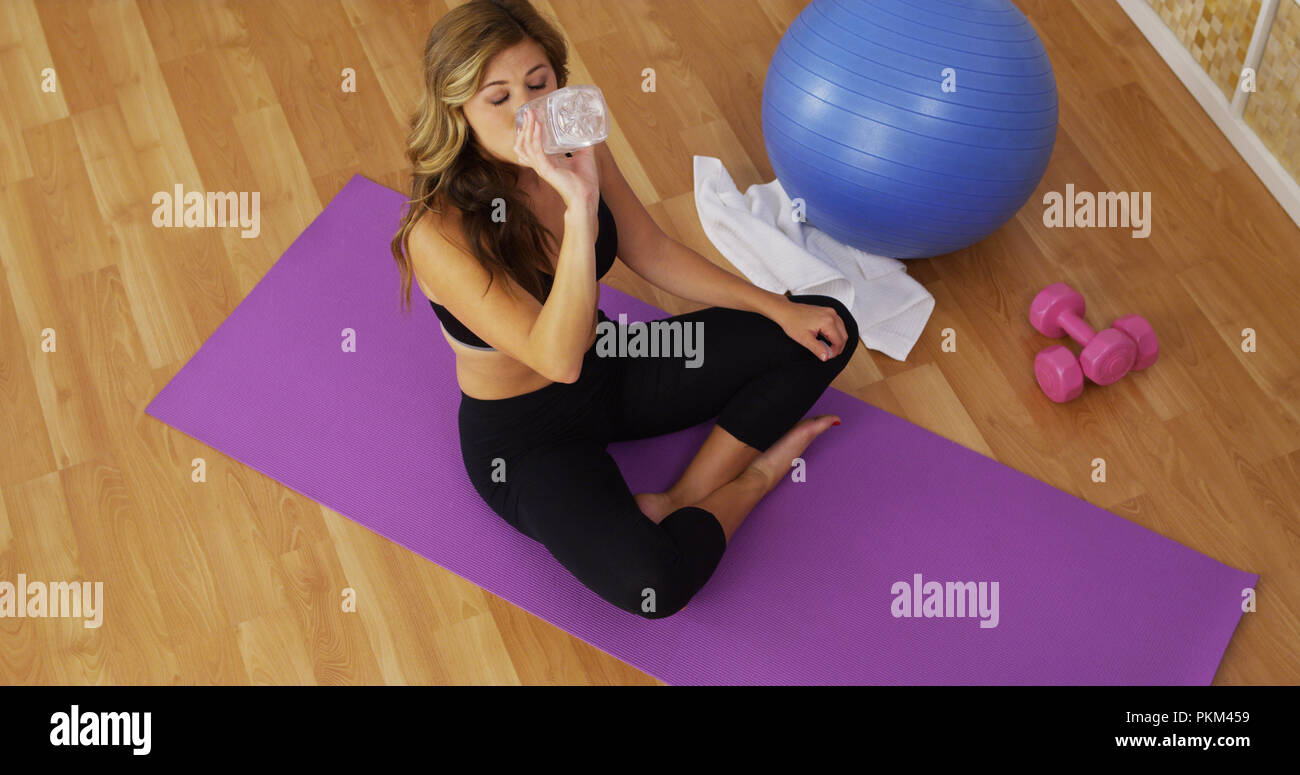 Healthy young woman drinking water after exercising Stock Photo Alamy