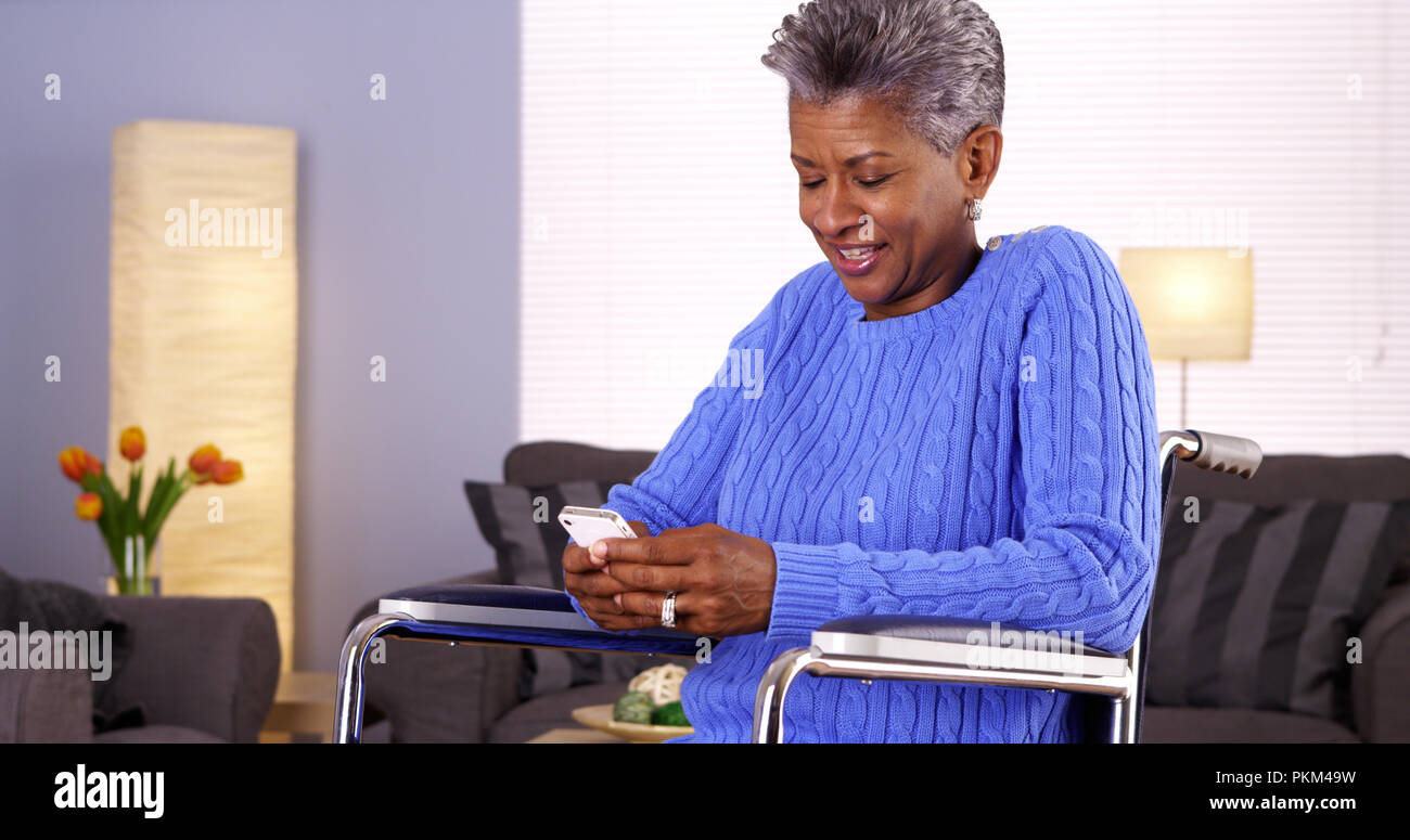 Smiling black woman texting messaging hi-res stock photography and ...