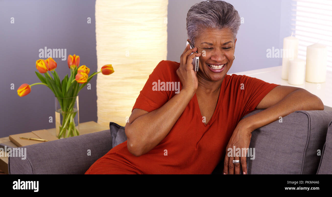 African grandmother talking on smartphone Stock Photo - Alamy