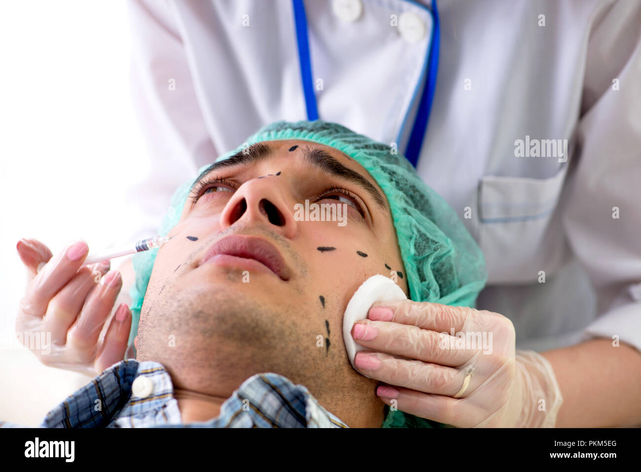Plastic surgeon preparing for operation on man face Stock Photo - Alamy