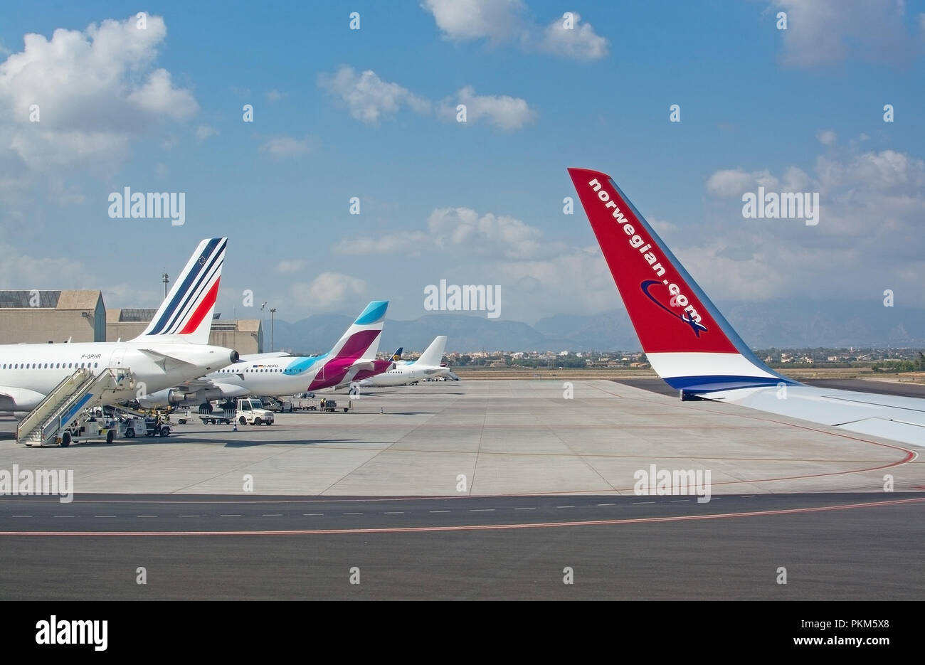 PALMA DE MALLORCA, SPAIN - SEPTEMBER 6, 2018: Airplanes from various companies on the tarmac outside gates on a sunny day on September 6, 2018 in Mall Stock Photo