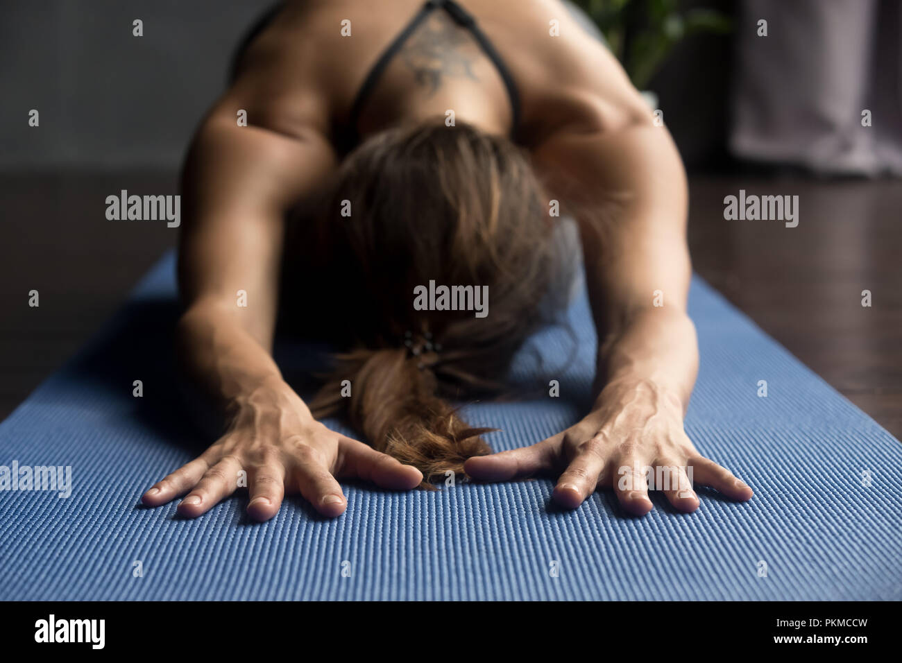 Young sporty woman in Balasana pose, close up view Stock Photo