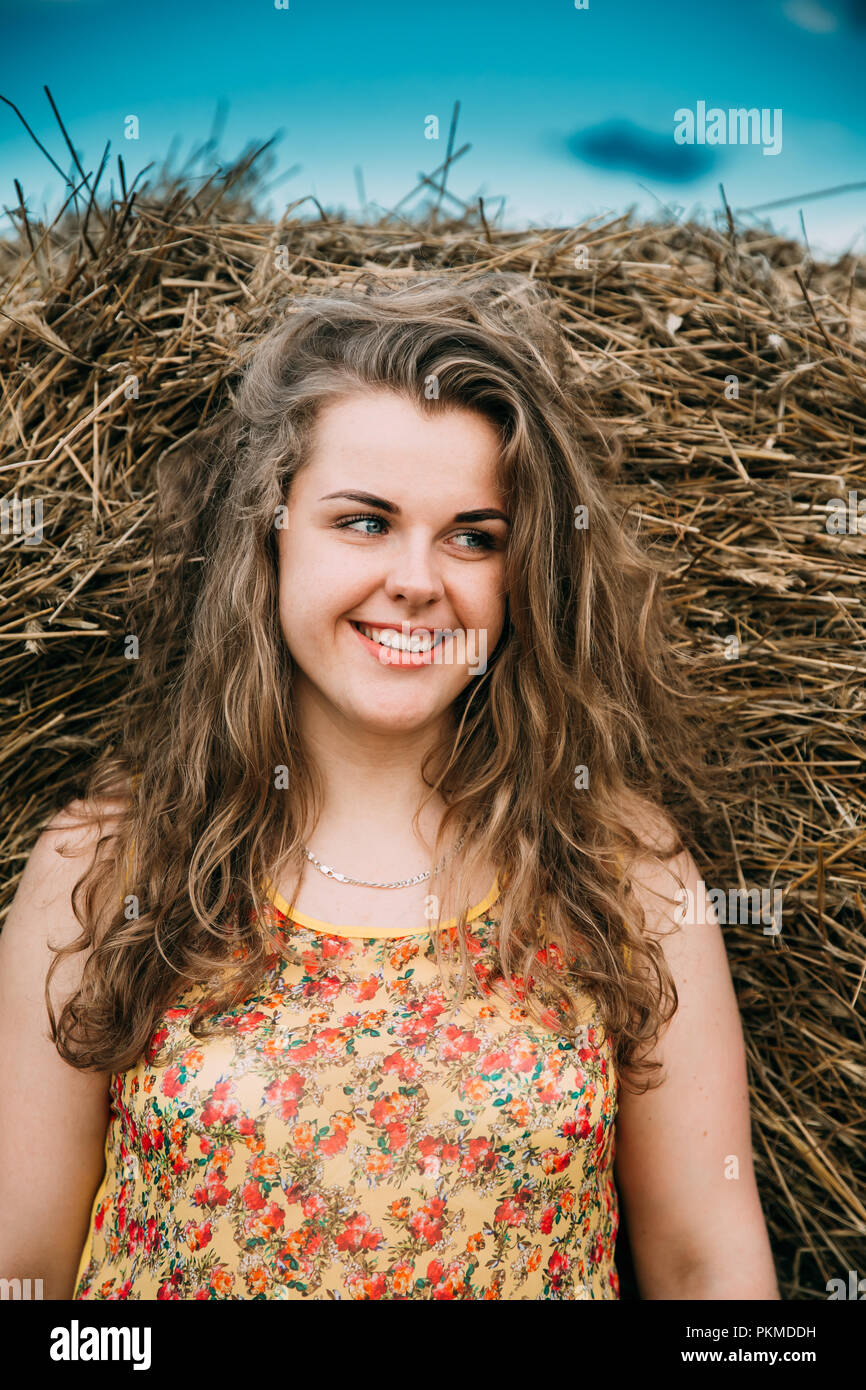Portrait Beautiful Plus Size Young Woman Standing Near Hay Bale In Summer Field. Close Up Stock Photo