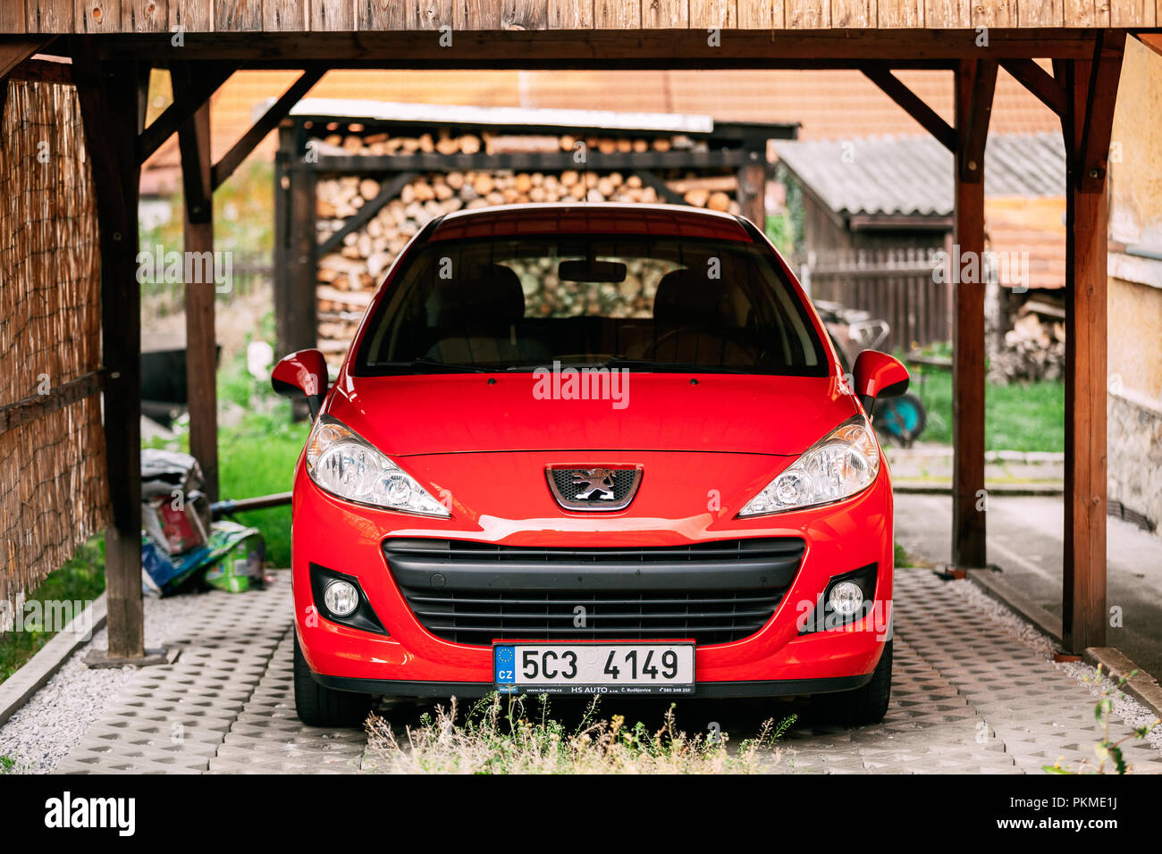 Cesky Krumlov, Czech Republic - September 26, 2017: Red Peugeot 207 Car Parked In Yard. Peugeot 207 was a supermini produced by the French automaker P Stock Photo