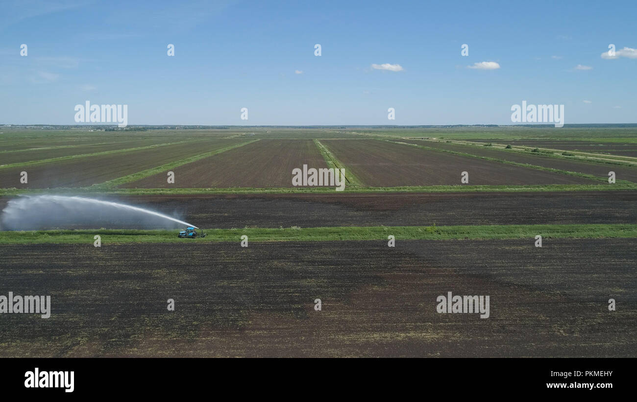 Aerial view of Crop Irrigation using the center pivot sprinkler system. An irrigation pivot watering agricultural land. Irrigation system watering farm land. Stock Photo
