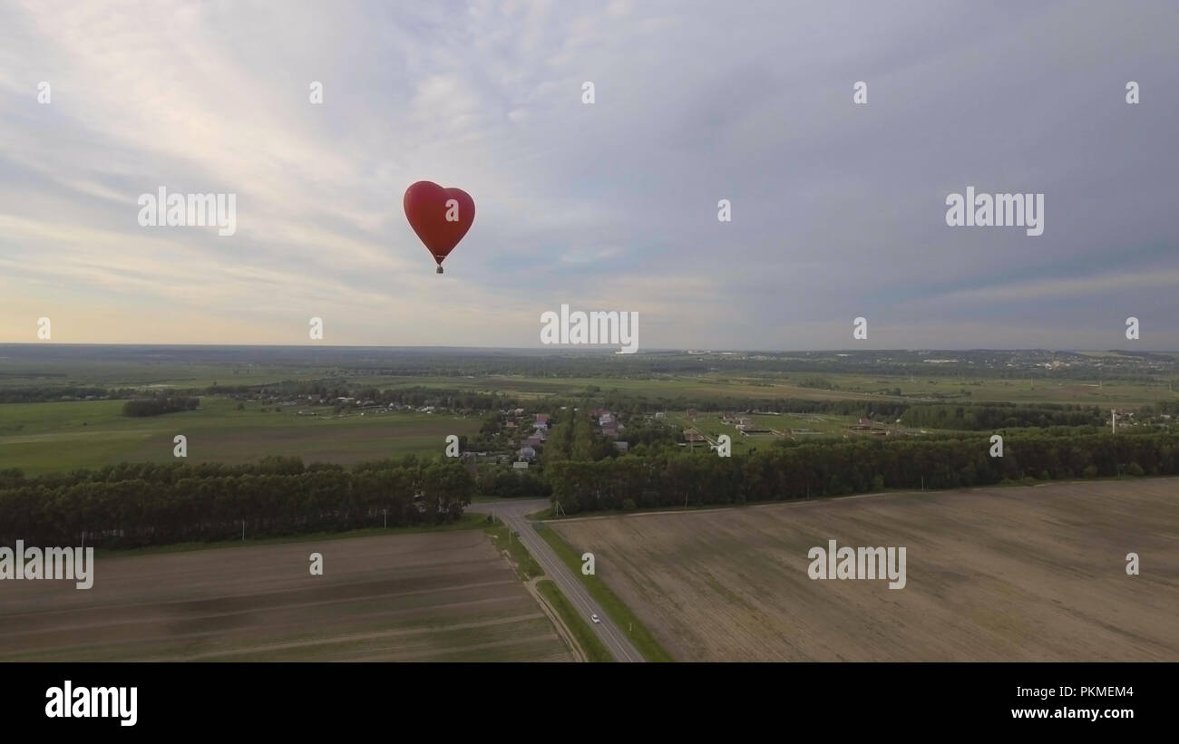Hot air balloon shape of a heart in the blue sky. Aerostat, Airship ...