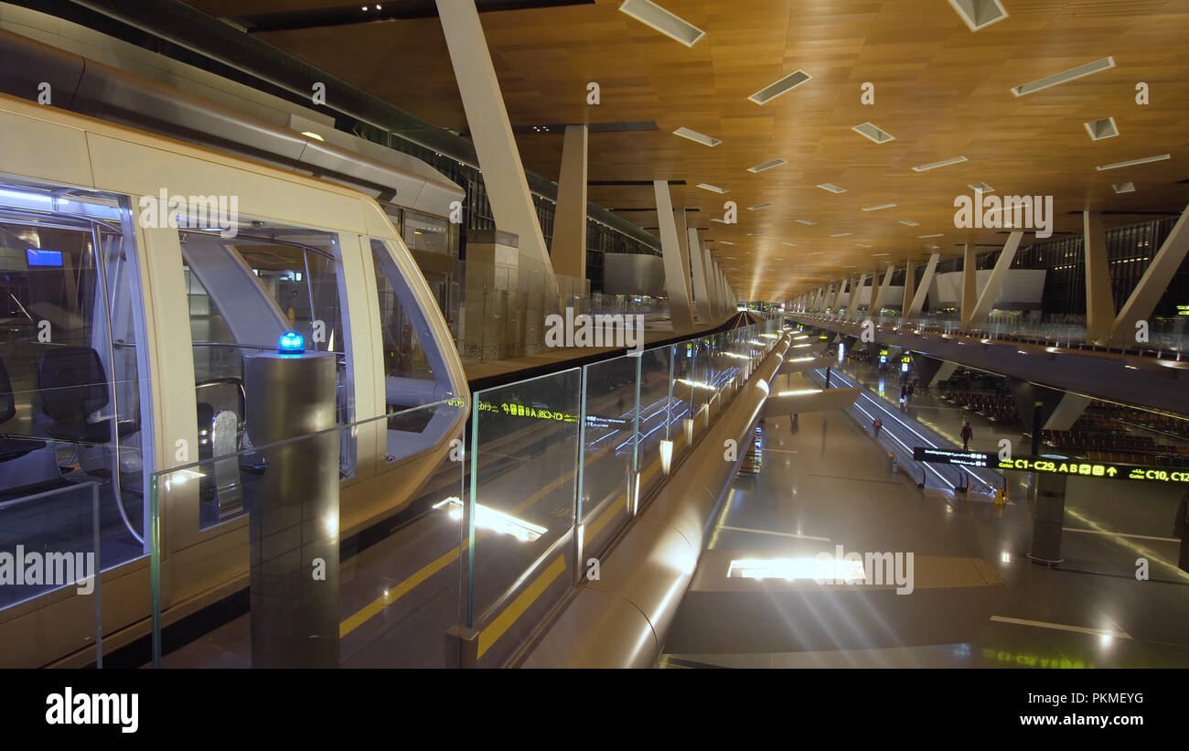 Monorail with train at Doha International Airport, Qatar. Train on the ...