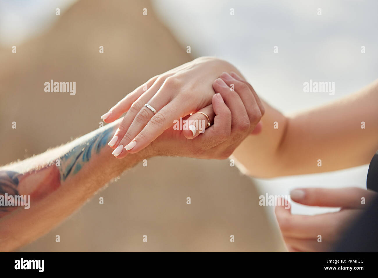 Man makes a marriage proposal to his girlfriend. Engagement of a couple in love in nature. The guy wears a wedding ring on a woman's finger. Happy emo Stock Photo