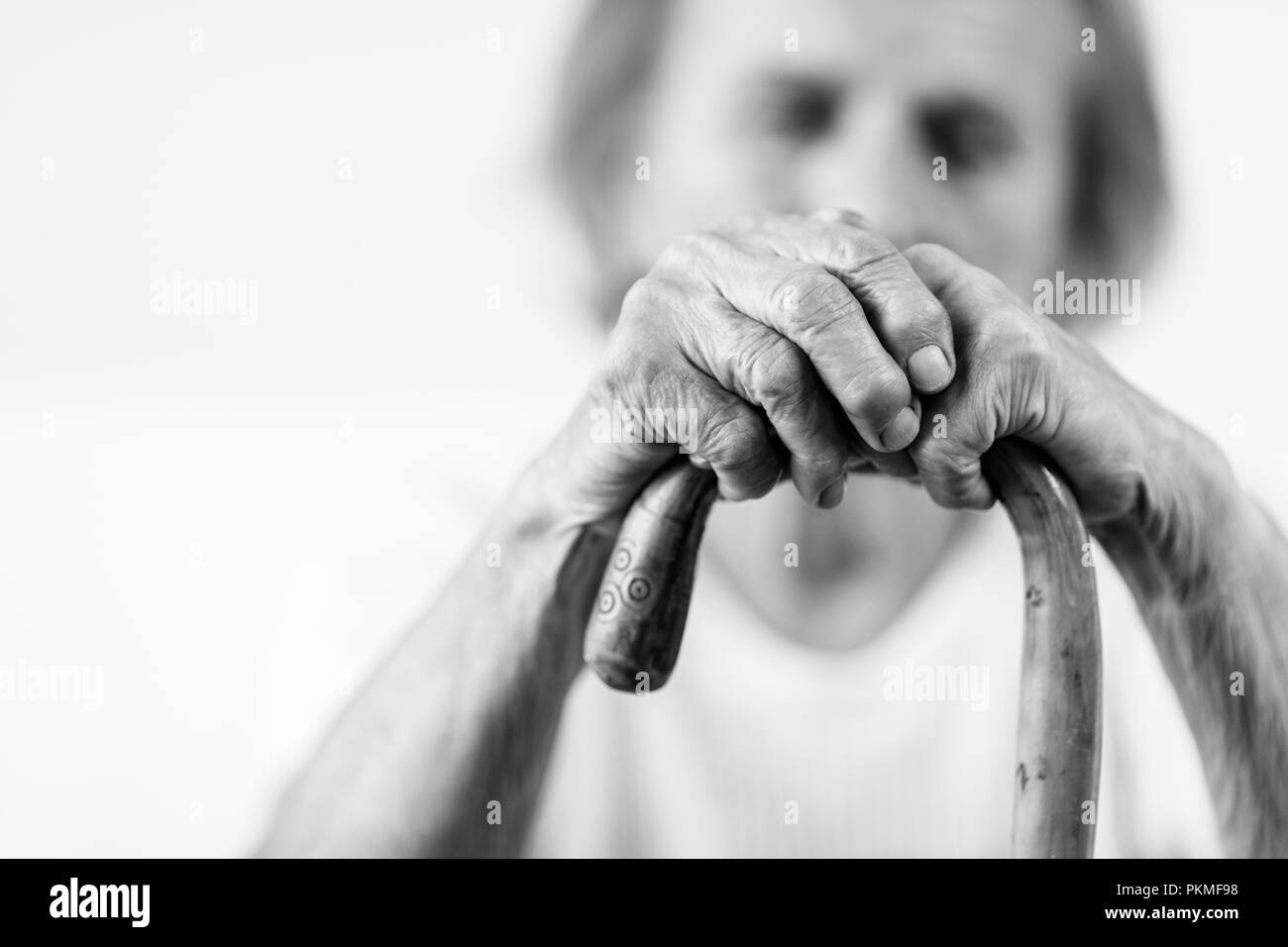 Elderly woman in the 80s with a walking stick Stock Photo