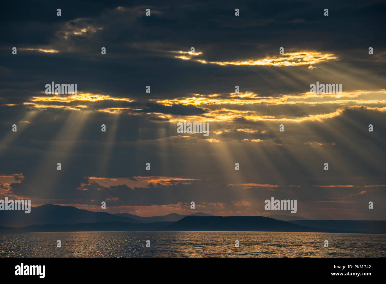 Sun breaking through the clouds above the Amur in Vladivostok, Russia Stock Photo