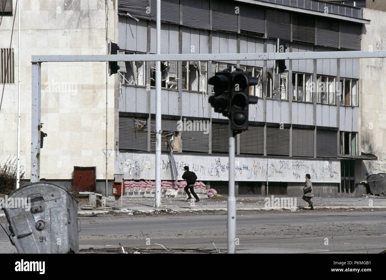 15th March 1993 During the Siege of Sarajevo: people run from the sniper near the Hotel Bristol on Sniper Alley. Stock Photo