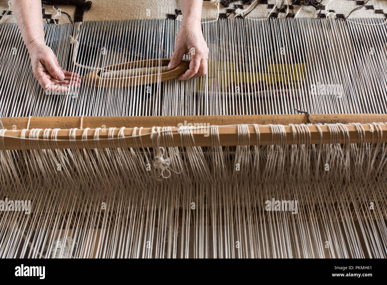 Weaving loom and shuttle on the warp. Weaving background and sample