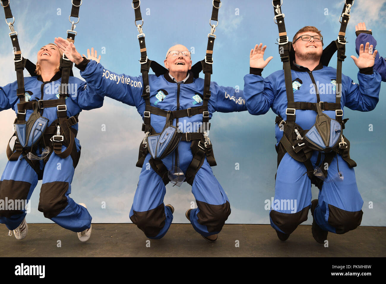 D-Day veteran Harry Read, 94, with his granddaughter Jo Taylor, 38, and great grandson Josh Shaw, 23, practising a skydive position at Old Sarum Airfield, Salisbury, Wiltshire, where he is taking part in his first high level skydive since he parachuted into Normandy on 6 June 1944. Stock Photo