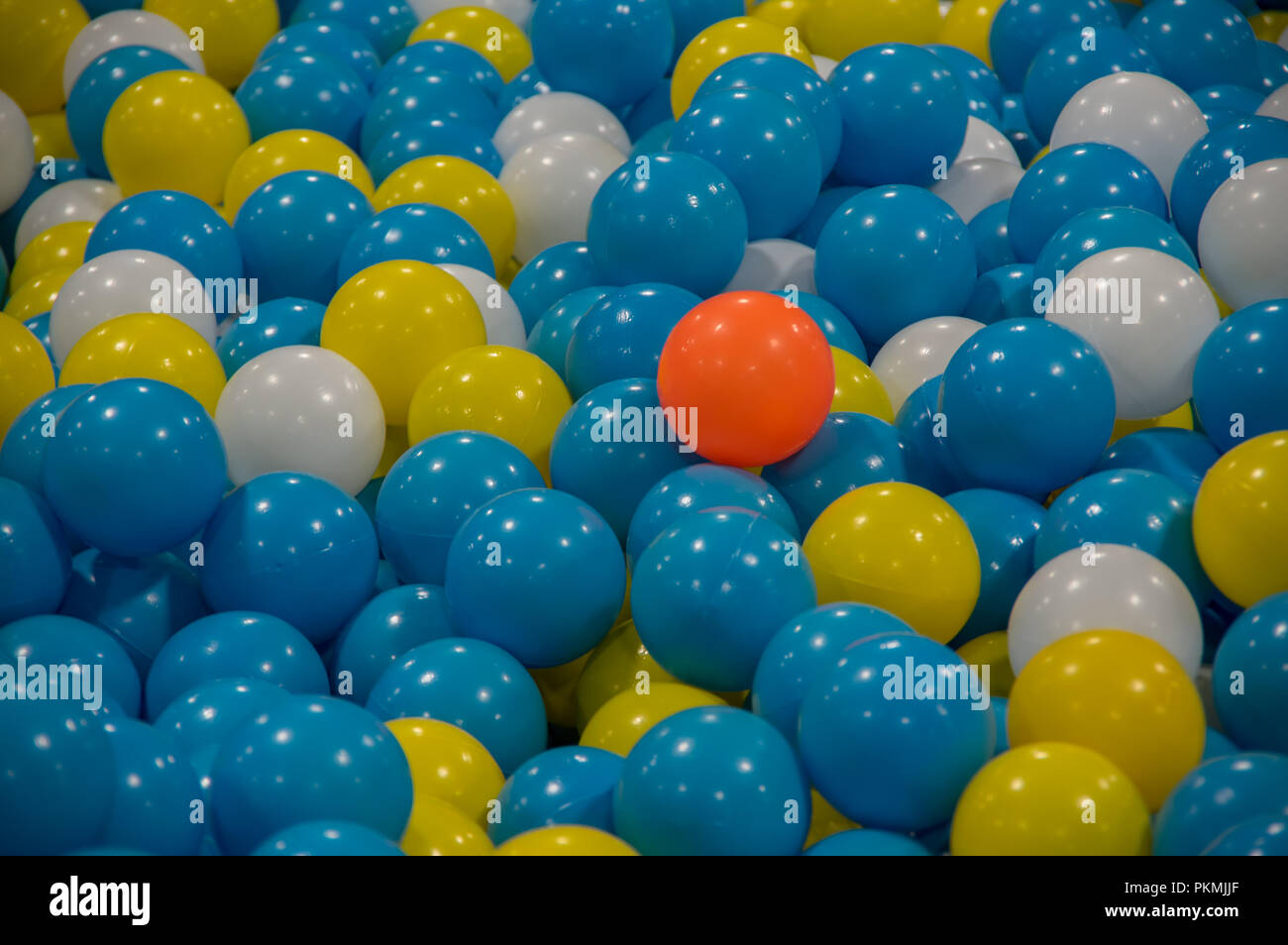 background with colorful plastic balls, red and yellow middle blue