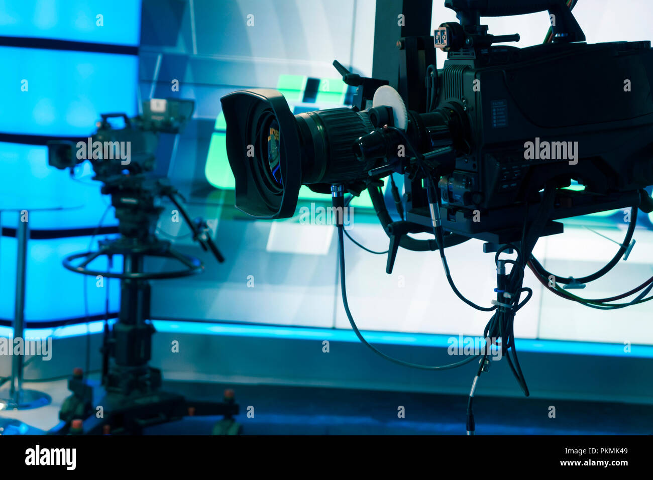 Broadcast television studio camera and crane camera in news studio room with LED lights Stock
