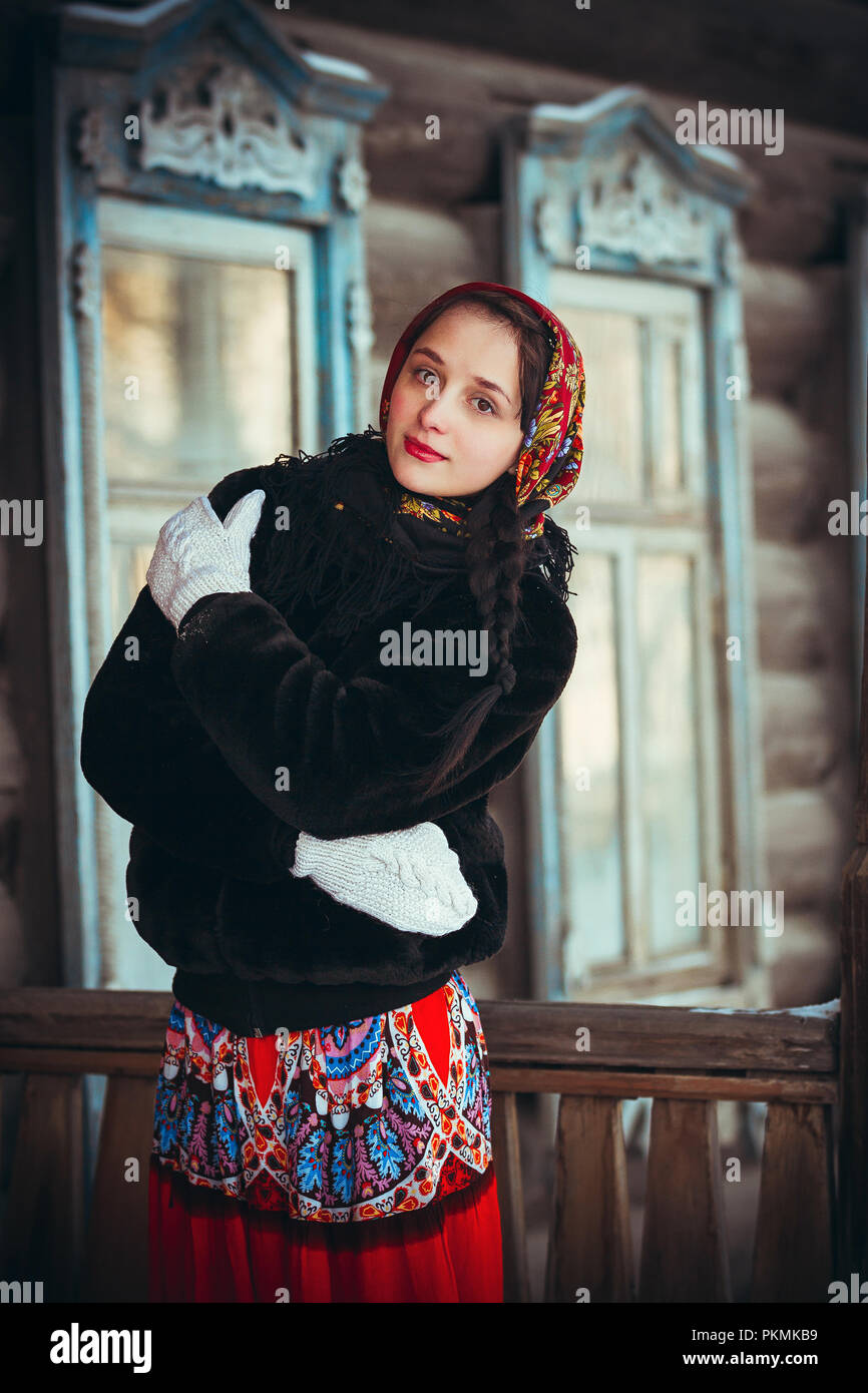 https://c8.alamy.com/comp/PKMKB9/russian-girl-in-the-winter-in-the-village-near-the-old-house-beautiful-woman-in-winter-scarf-on-head-PKMKB9.jpg