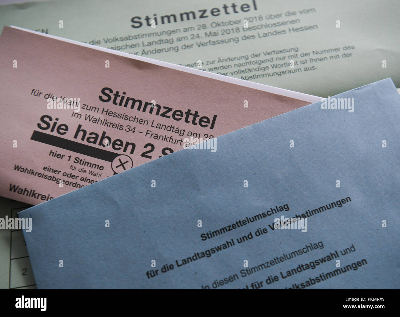 14 September 2018, Hessen, Frankfurt Main: ILLUSTRATION - A ballot envelope and ballot paper for the Landtag (state legislature) elections in Hesse and for the referendum on amendments and supplements to the state constitution lying on a table at the Frankfurt electoral office. Particularly hasty voters will be able to cast their votes from 17 September 2018, about six weeks ahead of the state elections in Hesse. From this day on, the documents are available for postal voting at the municipal electoral offices. Photo: Arne Dedert/dpa Stock Photo