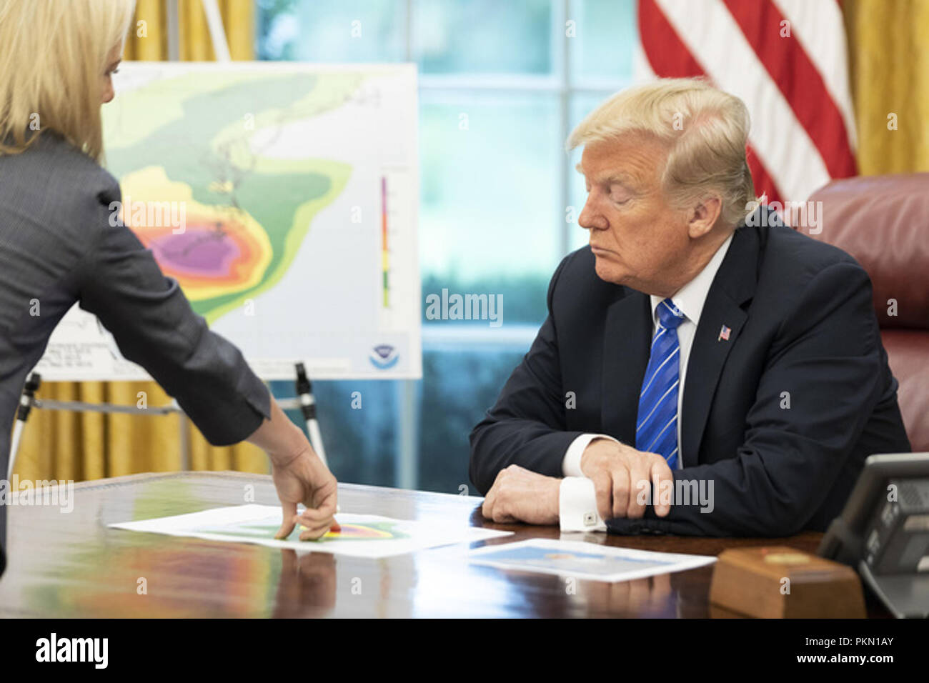 President Donald J. Trump, joined by Vice President Mike Pence and Secretary of Homeland Security Kirstjen Nielsen, receives an emergency preparedness briefing on Hurricane Florence Thursday, Sept. 13, 2018, in the Oval Office of the White House  People:  President Donald Trump Stock Photo