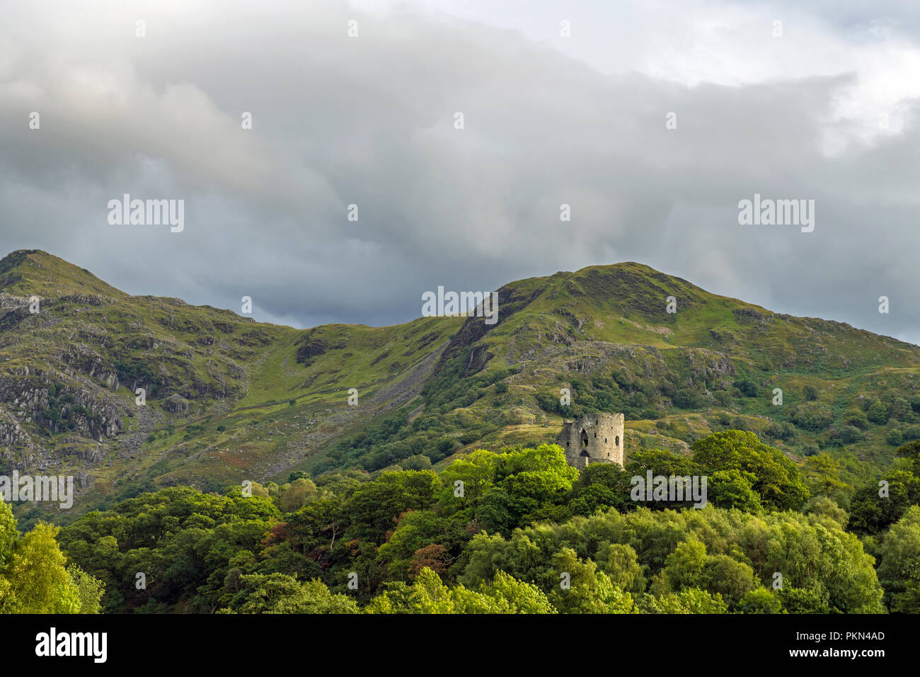 Dolbadarn Castle on the shore of Llyn Peris in the Snowdonia National Park, North Wales with a brooding sky. Stock Photo