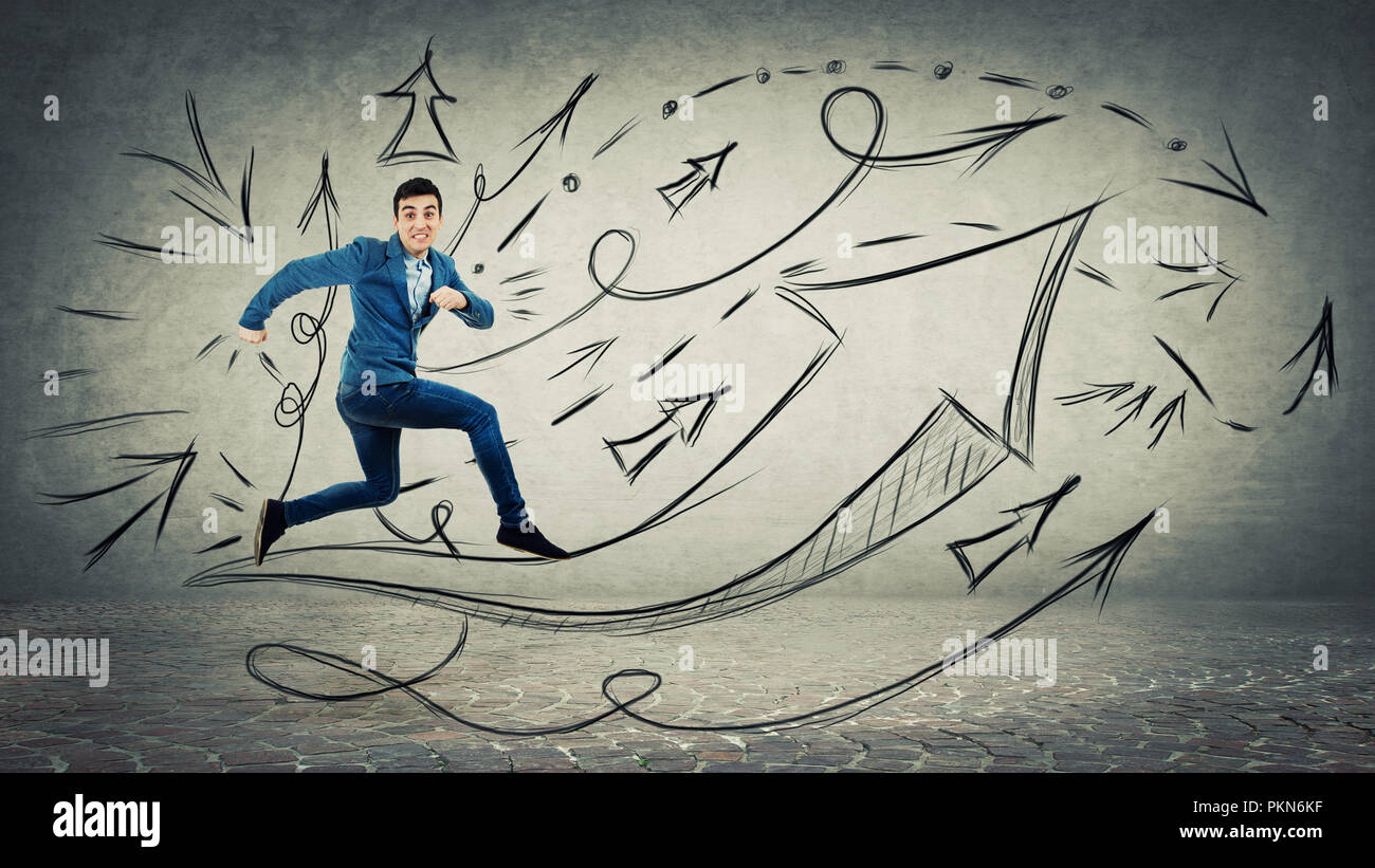 Businessman running and jumping over concrete wall background with ...
