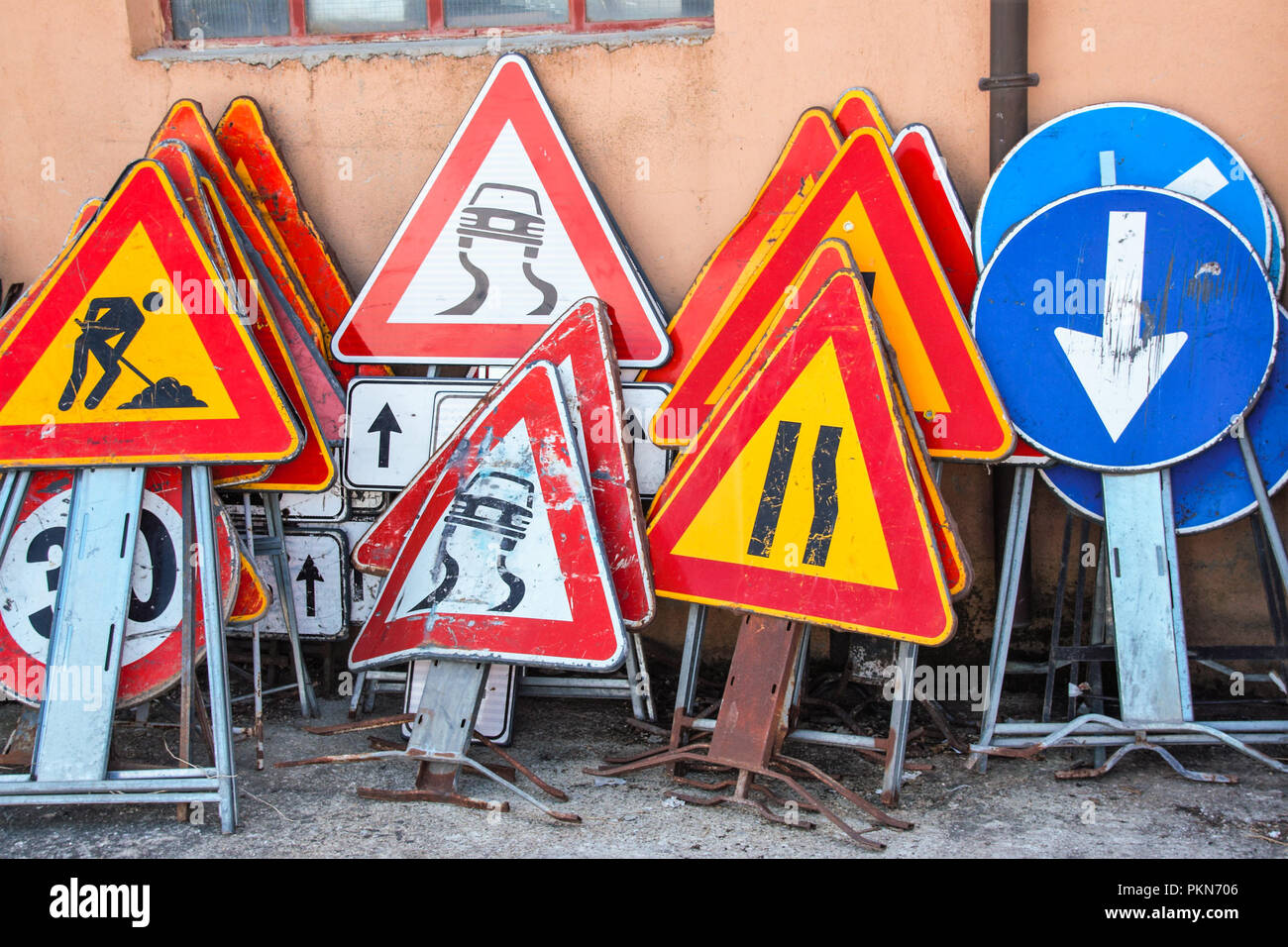 old herded road signs with different indications Stock Photo - Alamy