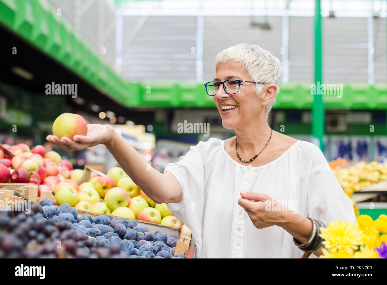 Portrait of senior woman buying fruit on market Stock Photo
