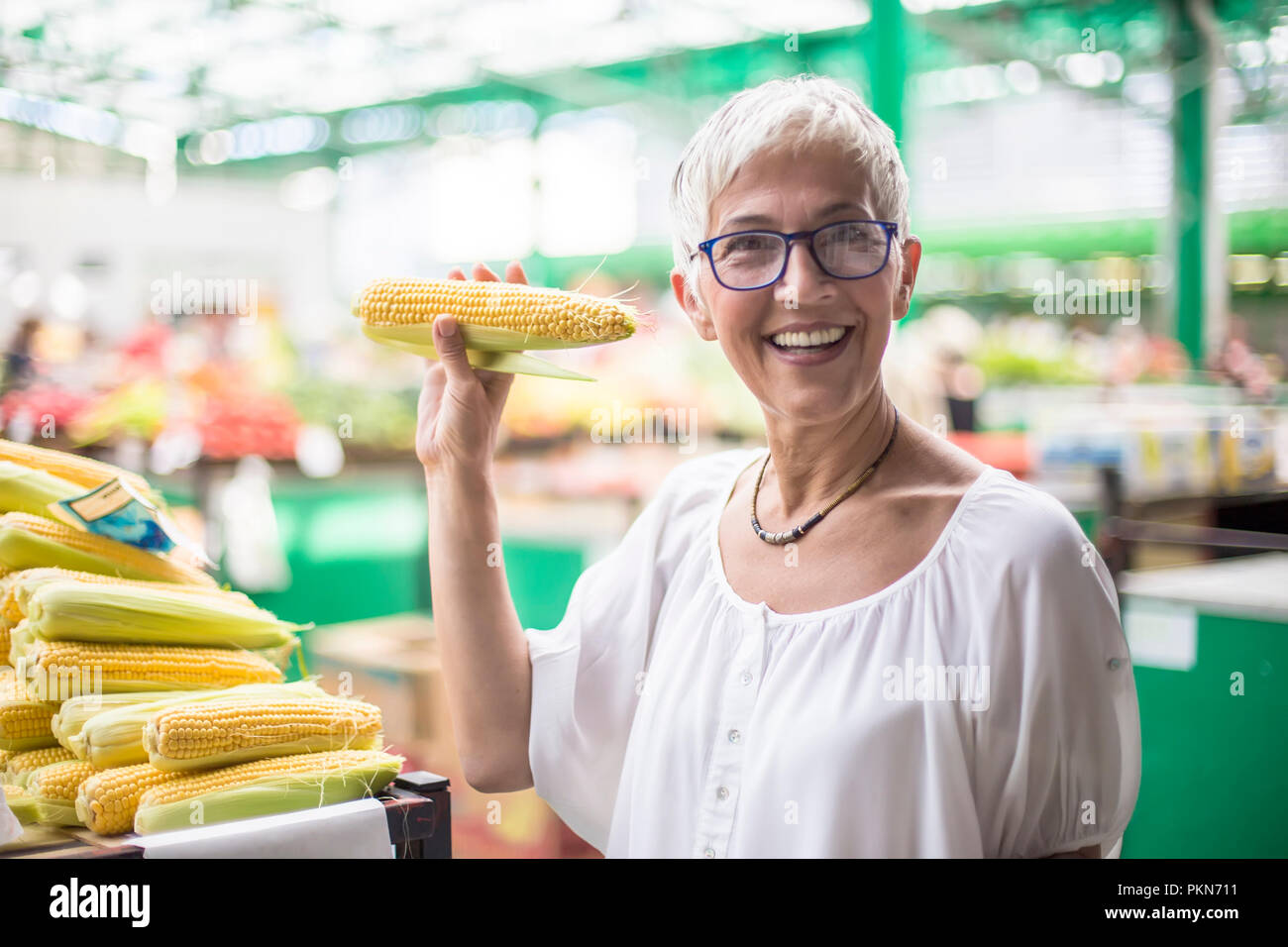 Portrait of senior woman buying on market Stock Photo