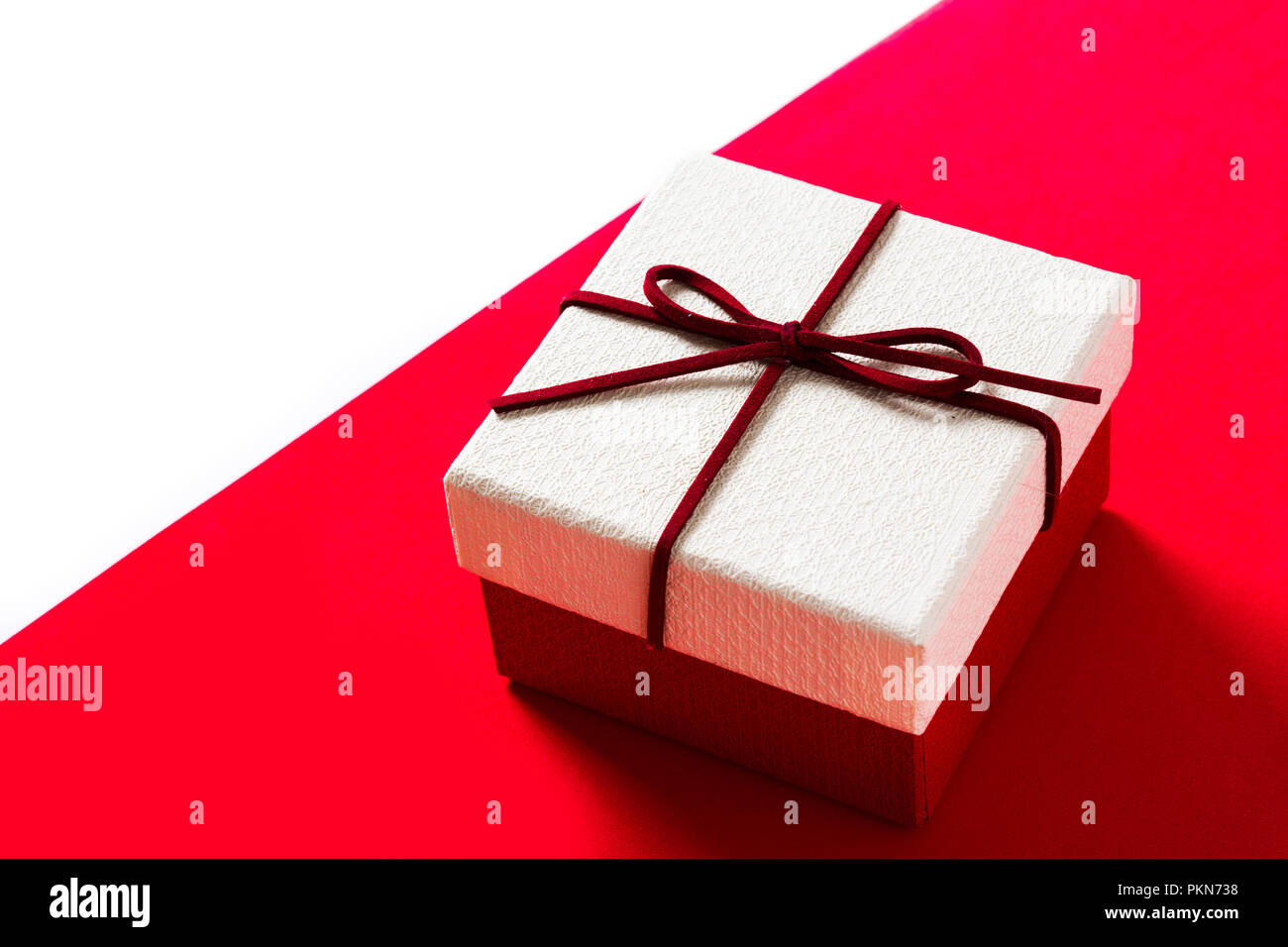 White gift box on red and white background. Copyspace Stock Photo - Alamy