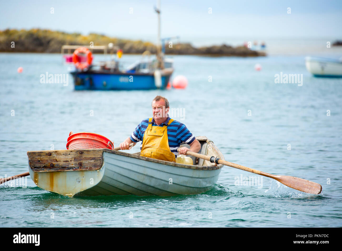 Action shot of traditional UK fisherman isolated in rowing boat