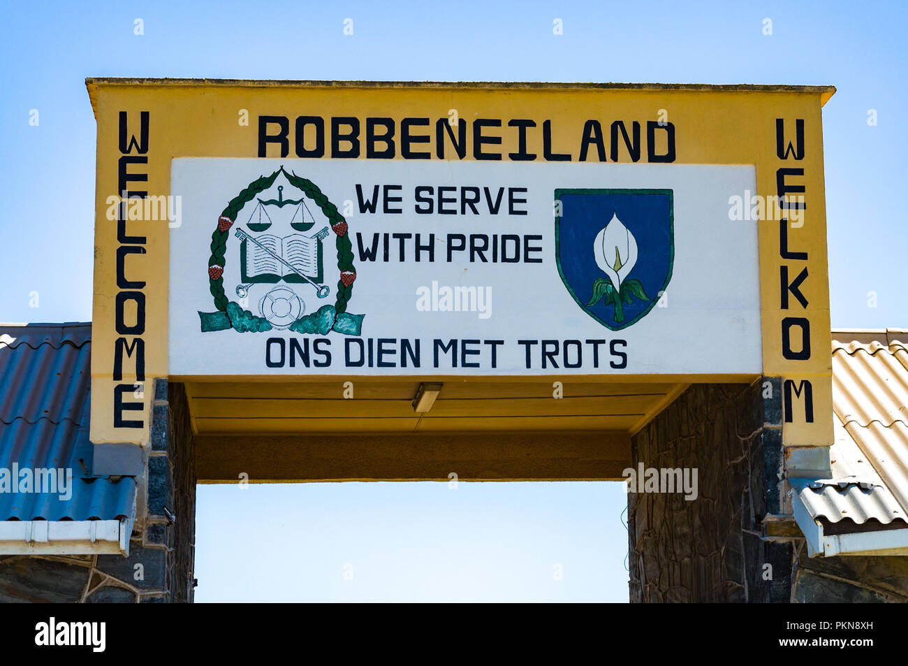 The welcome sign for Robben Island (Robbeneiland), South Africa, saying 'we serve with pride' Stock Photo